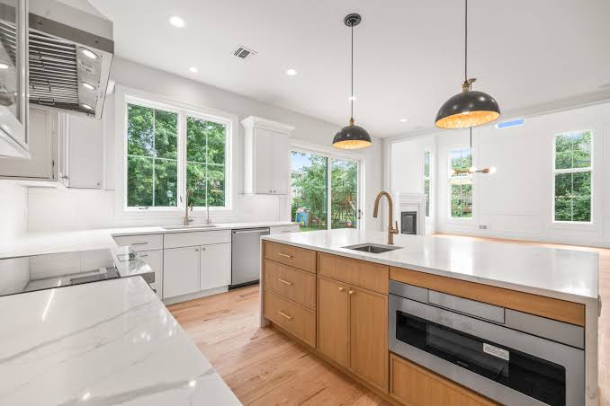 Cabinetry Brands 19 Tribeca Cabinetry kitchen with white cabinets and a natural oak island