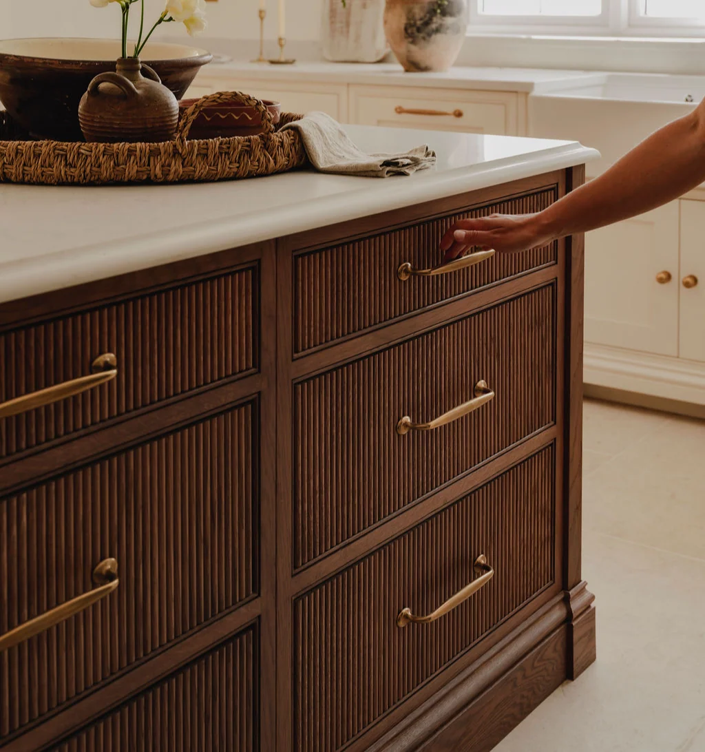 Hardware 5 Aged brass arched pulls on fluted walnut kitchen island drawers