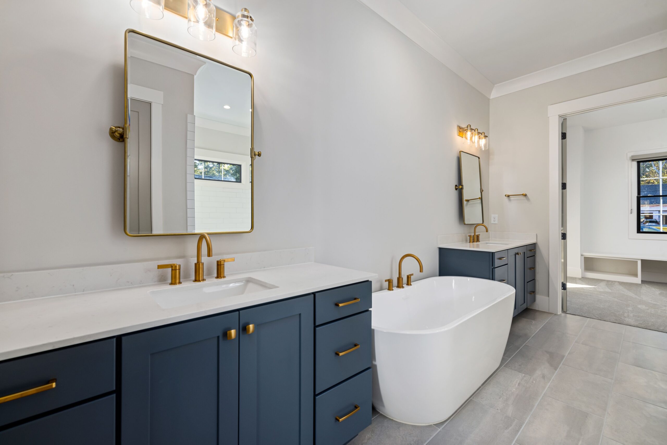 Blue double bathroom vanity with gold hardware and a white countertop