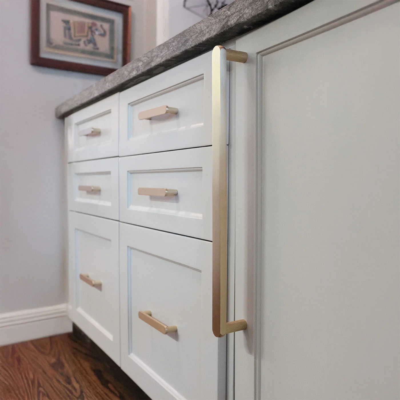 Brass knobs on sage green shaker cabinets
