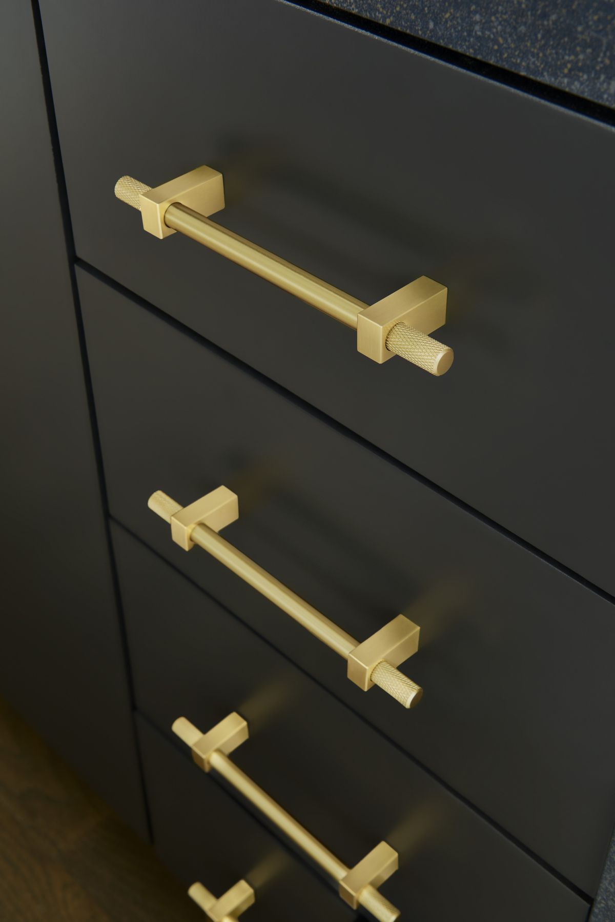 Hardware 3 Brushed brass knurled bar pulls on matte black kitchen drawers