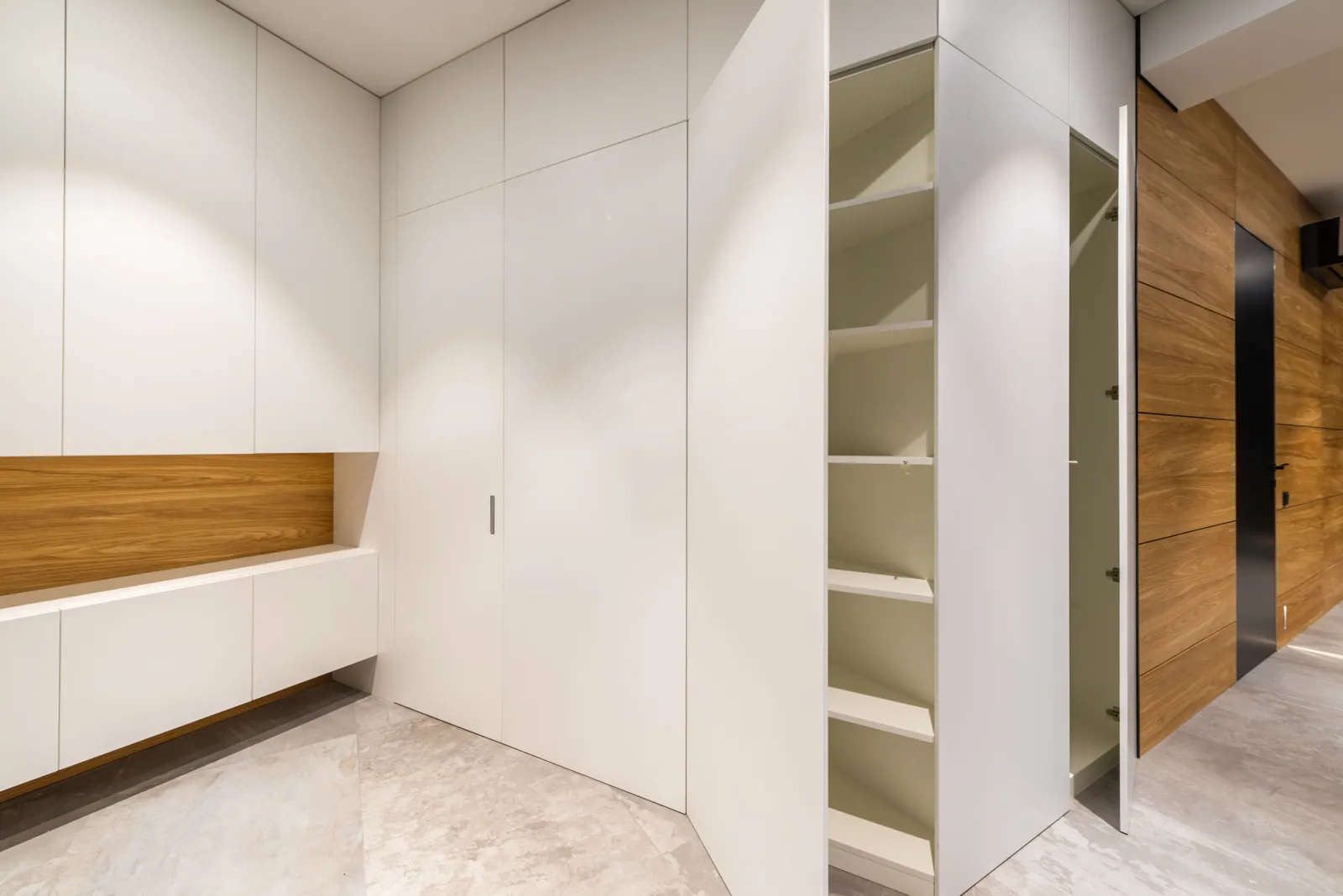Custom Closets 4 Built-in wardrobe wall with flush doors, open shelves and a wood-accent niche