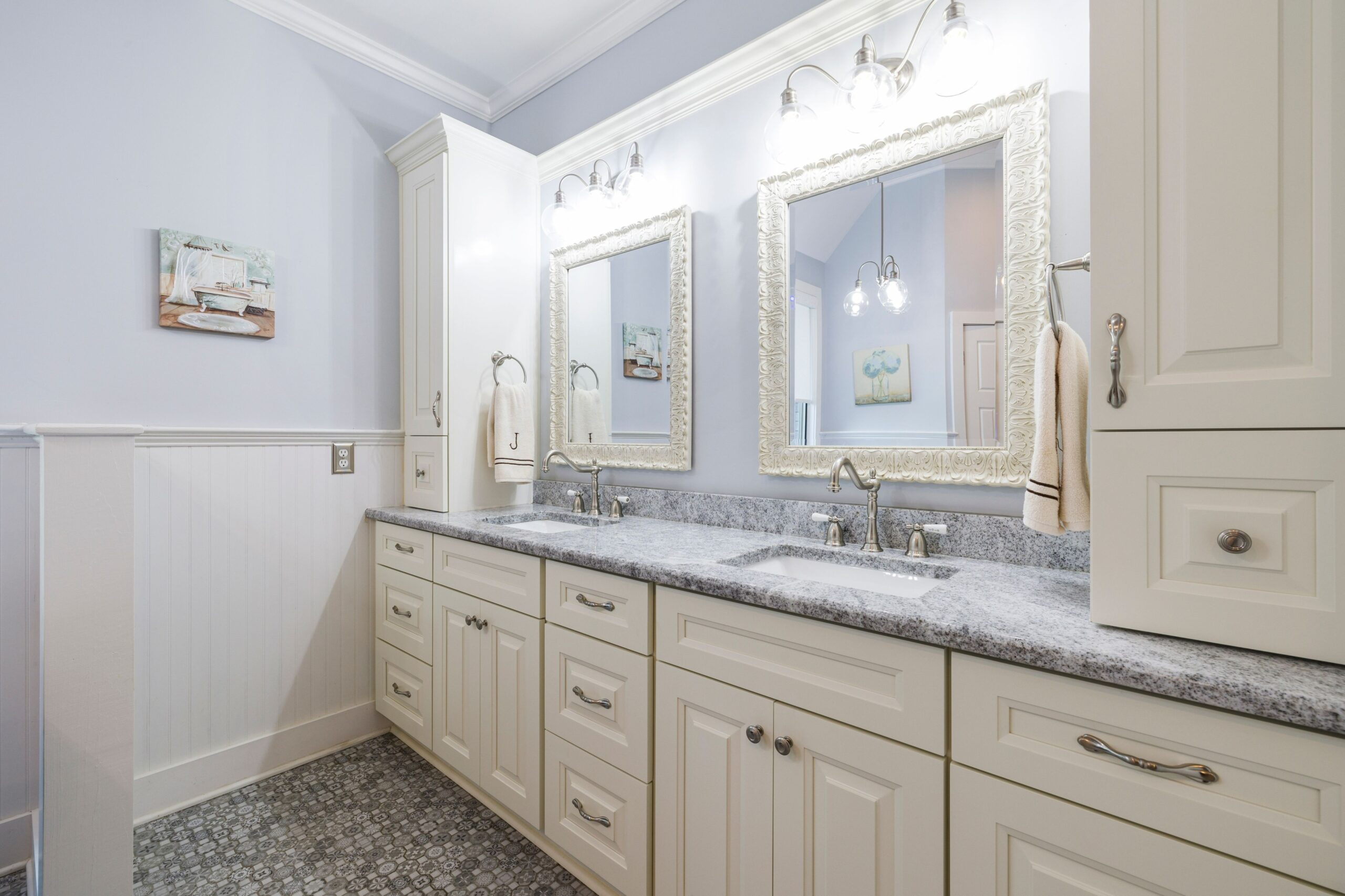Cream raised-panel double bathroom vanity with tall cabinets and a gray granite top