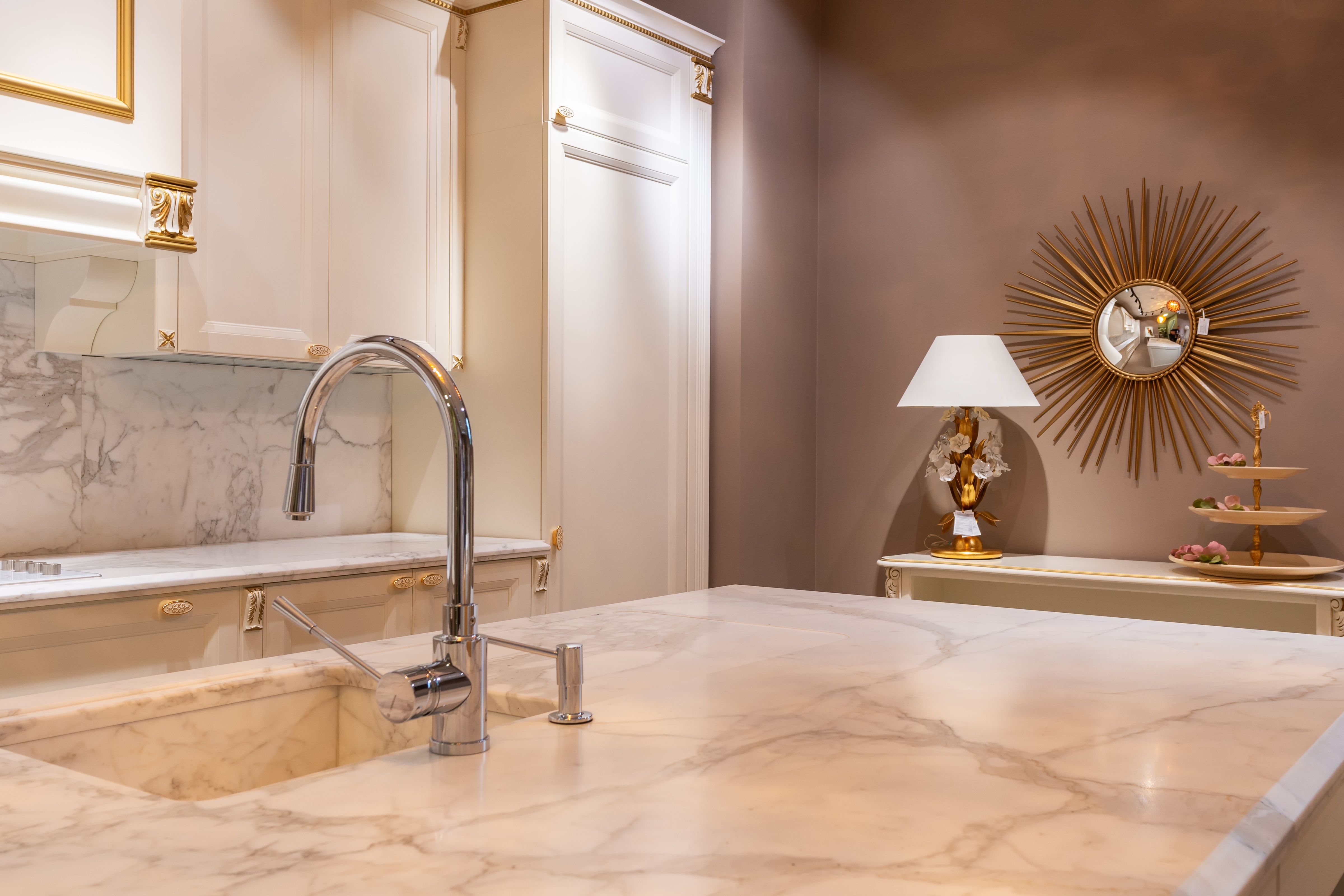 Cream veined vanity countertop with an undermount sink and a brushed nickel faucet