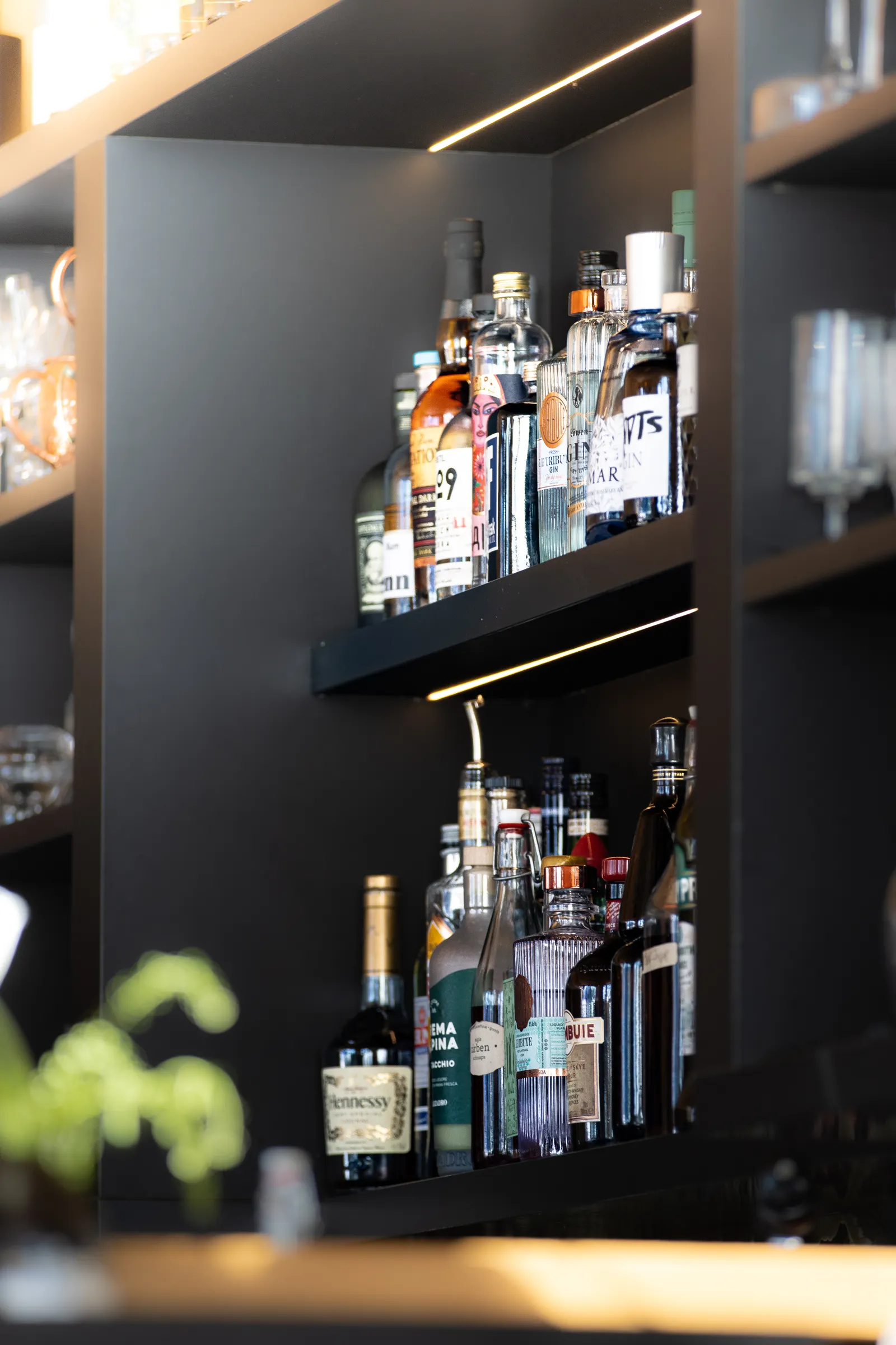 Bar Cabinets 2 Dark built-in bar shelving with liquor bottles and glassware