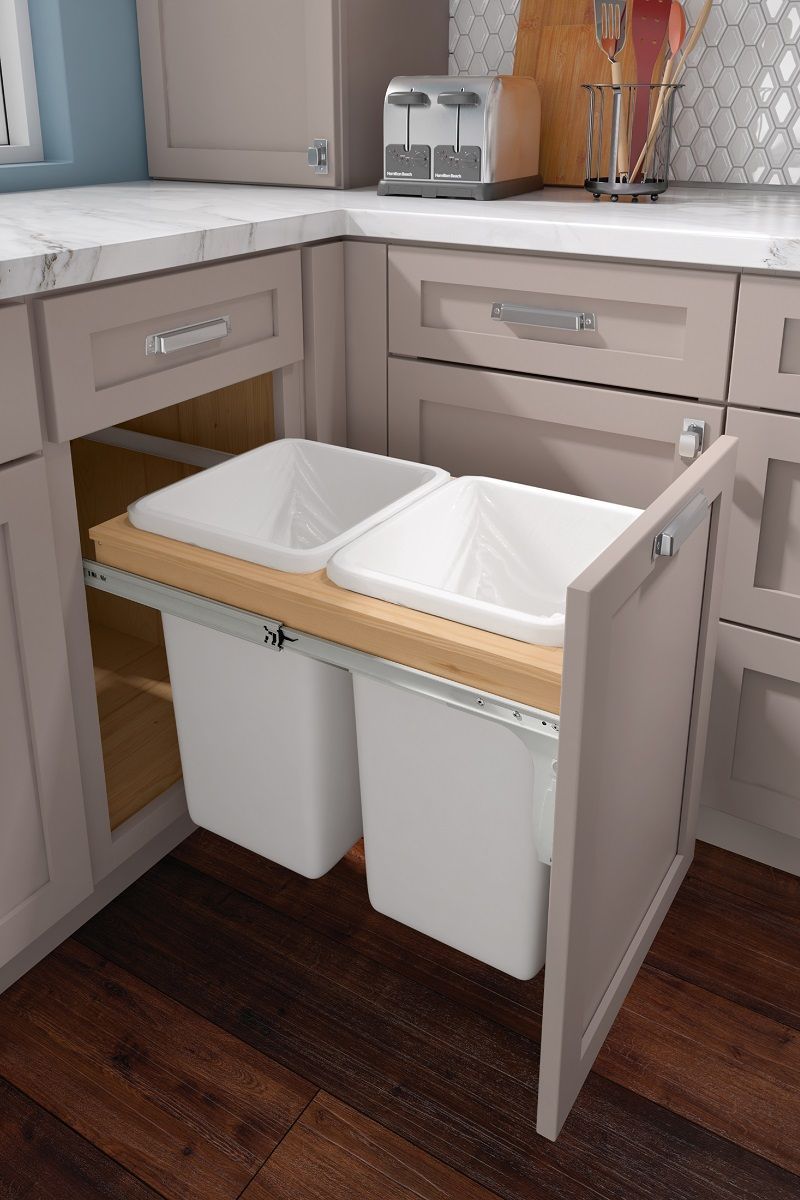 Double trash can pull-out in a gray shaker base cabinet
