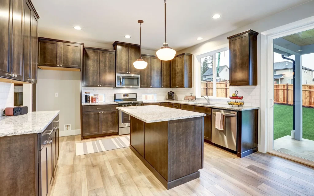 Cabinetry Brands 13 Everlasting Cabinetry kitchen with dark espresso Shaker cabinets and a light stone island