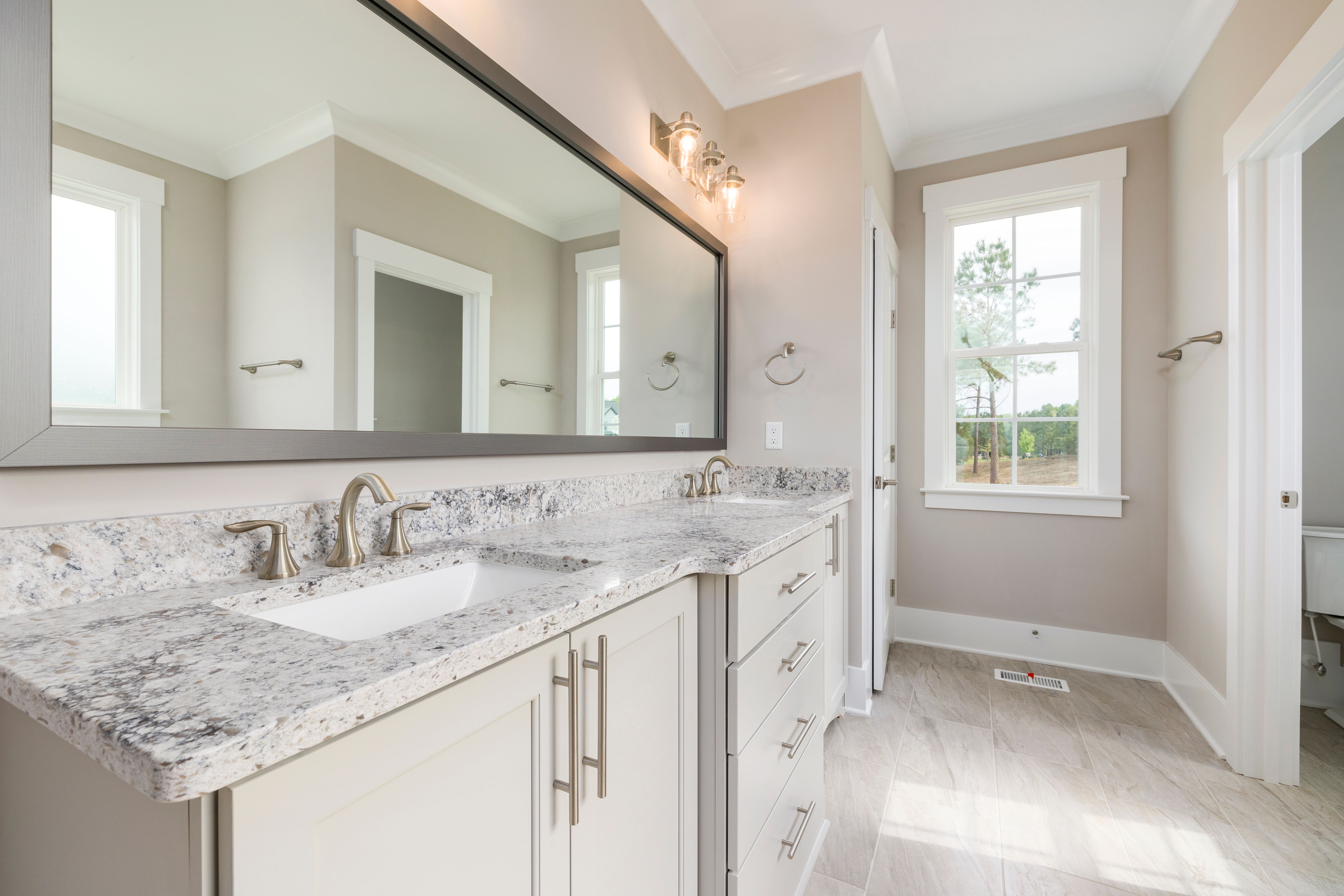 Double bathroom vanity with a speckled granite countertop and two undermount sinks
