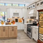 White kitchen cabinets with a wood island on display at the Kitchen Factory Newark showroom in Newark, NJ