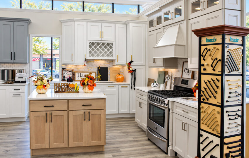 White kitchen cabinets with a wood island on display at the Kitchen Factory Newark showroom in Newark, NJ