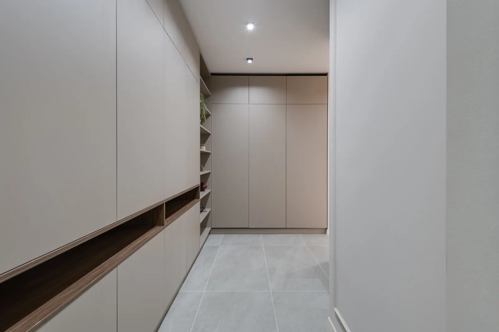 Custom Closets 5 Hallway lined with tall flush-door wardrobe cabinets and an open shelf niche