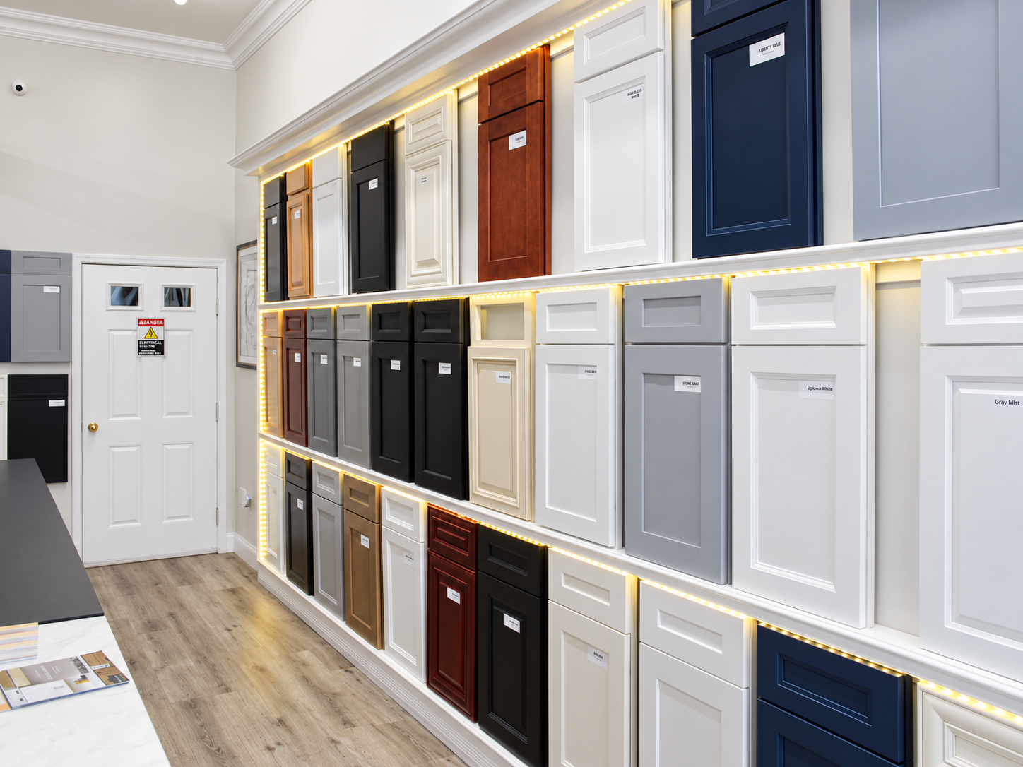 Kitchen cabinet displays and a cabinet door sample rack inside the Kitchen Factory Newark showroom