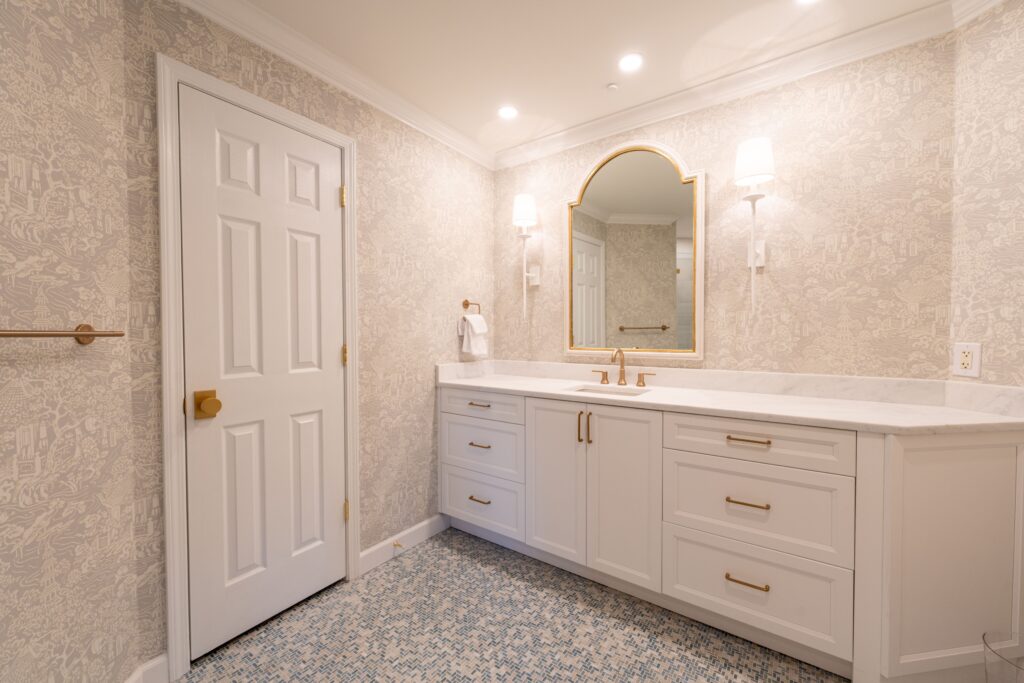 Queens, NY 4 White bathroom vanity with brass pulls and an arched gold mirror