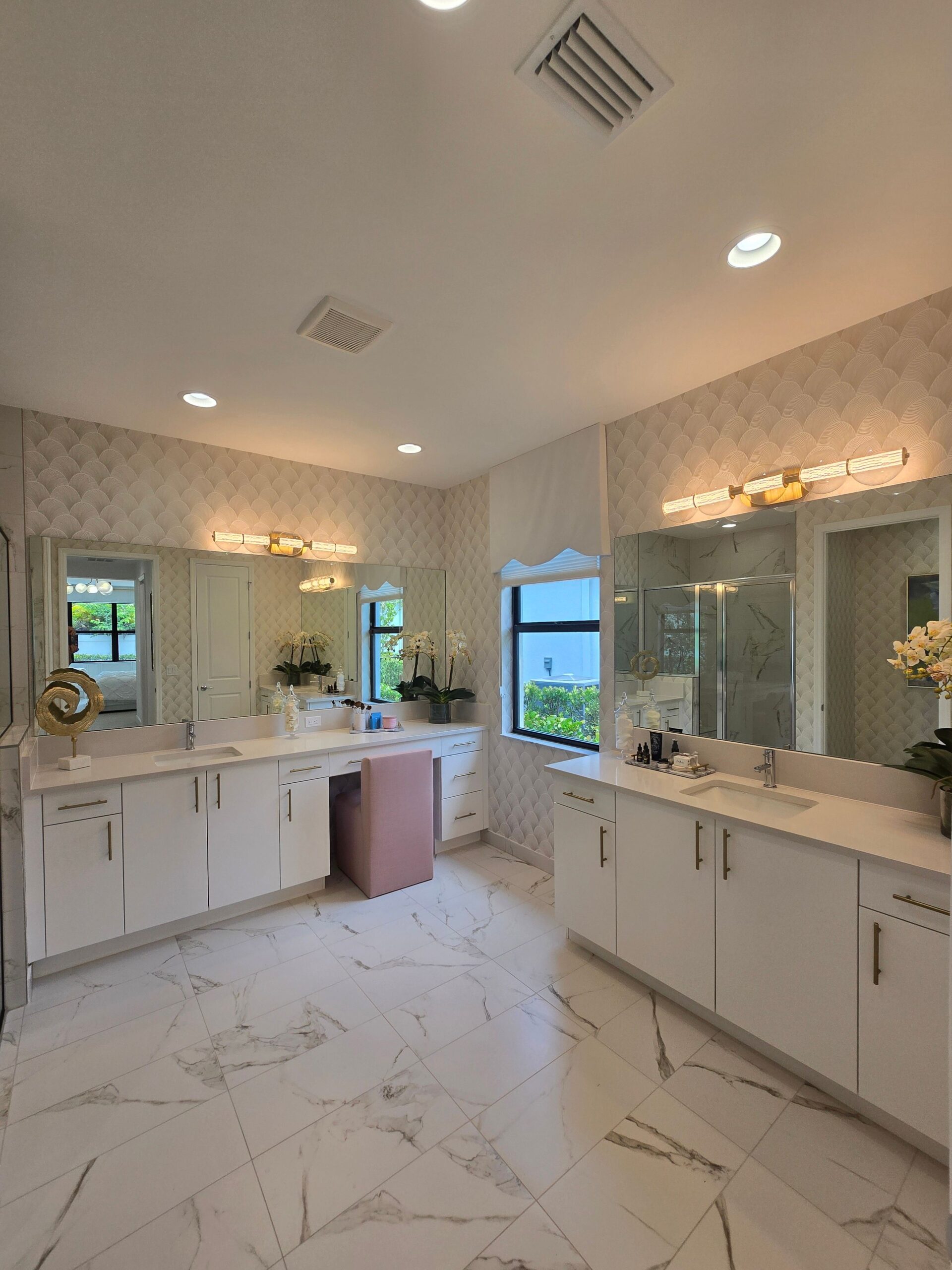 White double bathroom vanity with a built-in makeup station and gold pulls