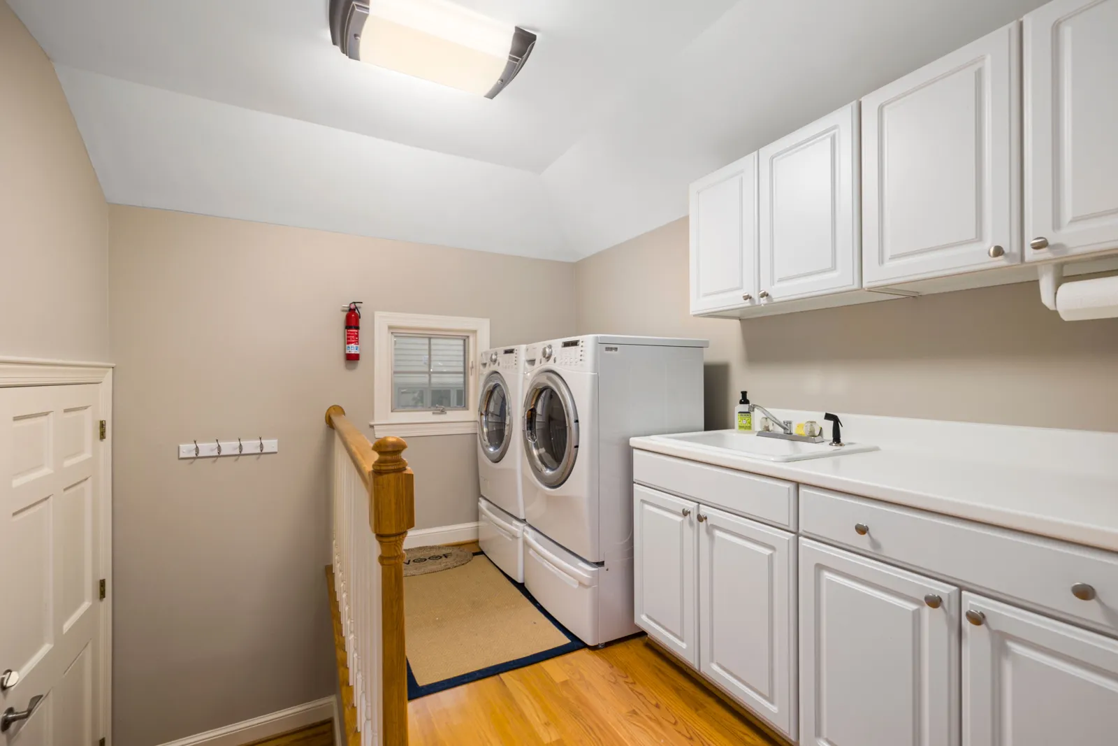 Kitchen Cabinets 16 White laundry room cabinets with a countertop beside a washer and dryer