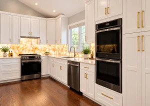 White kitchen with a range, double wall ovens and an amber onyx-look backsplash